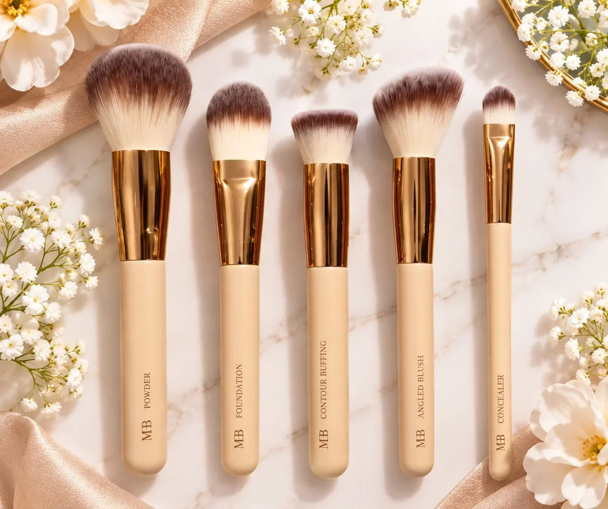 5-piece makeup brush set with cream handles, gold ferrules, and white to purple bristles